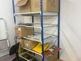 a room with a desk, shelves, and a chair in it