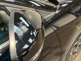 a black car with a mirror on the side of it