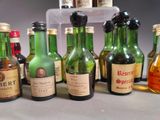 many bottles of alcohol lined up on a table