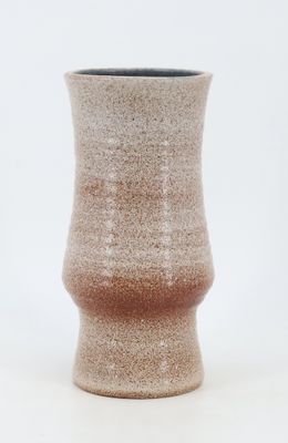 a close up of a vase on a white surface