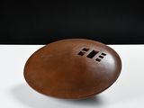 a brown football on a white table with a black background