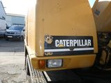 a yellow truck that is parked in a parking lot