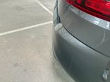 a car parked in a parking lot with a parking meter on the side of the road
