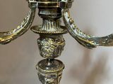 a silver candle holder with a bird on top of it