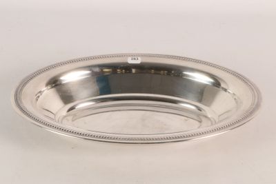 an image of a silver plate with a beaded edge