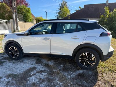 a white nissan rav parked in front of a house