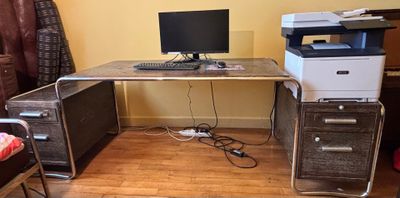 a computer desk with a printer on top of it