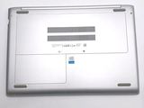 a silver laptop with a blue button on it