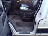 a white truck with the door open and the seats down