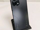 a close up of a cell phone on a stand on a table
