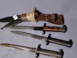 five different types of knives on a white surface