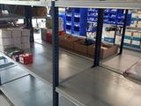 a metal shelf in the middle of a warehouse