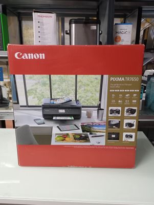 a canon printer sitting on a table in a store
