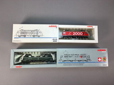 deux trains miniatures posés côte à côte sur une table