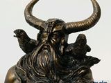 a statue of a man with a horned head and two birds on his head
