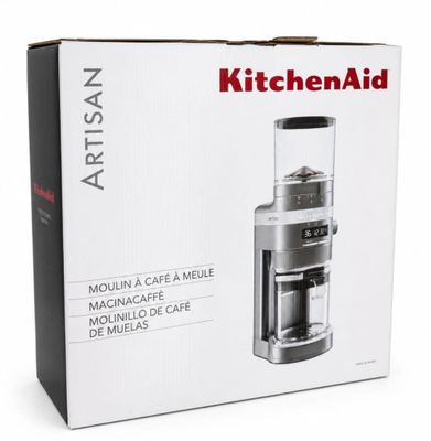 a box with a coffee grinder inside of it on a white surface