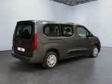 the grey van is parked in the large room of the building