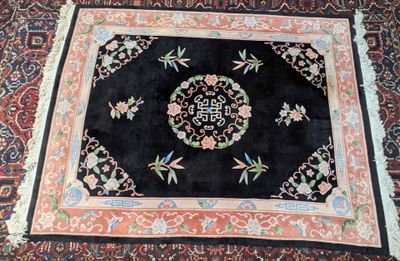 oriental rug with oriental design on black ground with red border