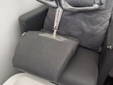 a reclining chair with a seat and a sink in the bathroom