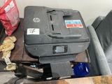 a printer sitting on top of a table next to a stuffed animal