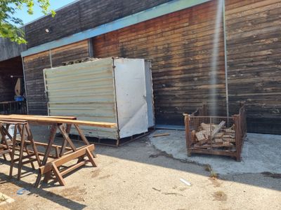 a refrigerator and a table in front of a building