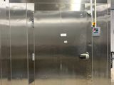 several stainless steel stalls are lined up in a large room