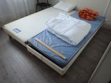 a bed that has a mattress on it in a room