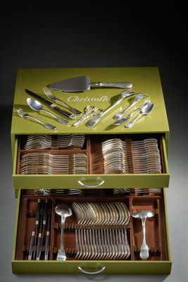 a green box with silverware in it on a table