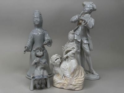 three figurines of people and a dog on a table