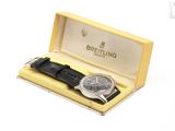 a watch in a yellow box with a black strap