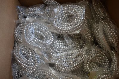 a box full of silver beads in it on a table
