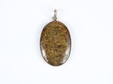a close up of a brown stone pendant on a white surface