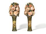two vases with flowers in them on a white surface