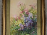 tableau représentant un tableau de fleurs dans un cadre doré, accroché au mur