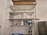 une étagère sur laquelle sont posés de nombreux récipients, dans la cuisine