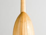 a wooden lamp hanging from the ceiling in a room