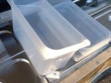 two plastic containers on the back of a truck