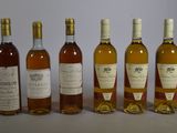 several bottles of wine are lined up on a table