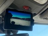 the rear view mirror of a car with a tv mounted to it ' s rear view mirror