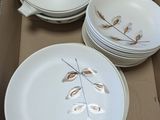 a cardboard box with a bunch of plates and bowls in it
