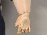 a close up of a doll ' s hand holding a doll ' s hand