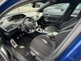 the interior of a blue car with a steering wheel and dashboard