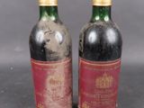 two bottles of wine sitting next to each other on top of a table