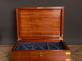an old wooden box with a blue velvet lining inside