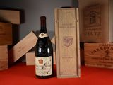 a bottle of wine sitting next to a wooden box
