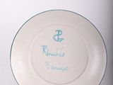a white plate with a blue anchor on it