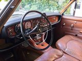 a brown leather car with a steering wheel and dashboard