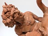 statue of a woman holding a bunch of flowers in her hands