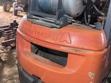 a forklift with a tank on top of it in a garage