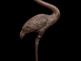 a bronze statue of a bird with a long neck and long legs